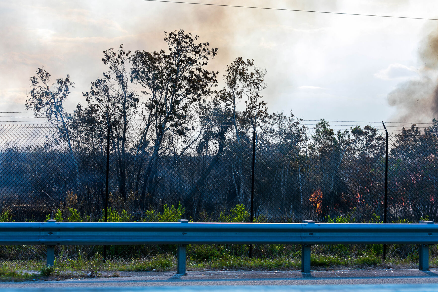 6 On Wednesday afternoon fire burns along the fence just west of US-5 just south of where the fire started.